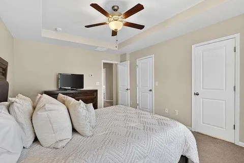 a bedroom with a bed and a tv