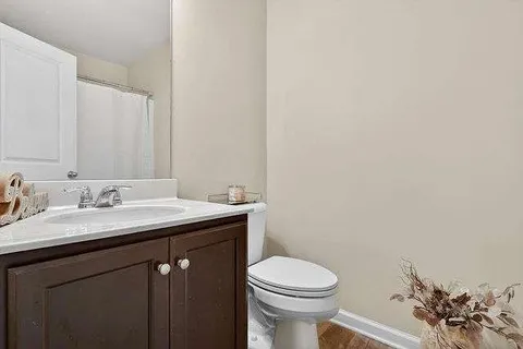 a bathroom with a sink a toilet and mirror