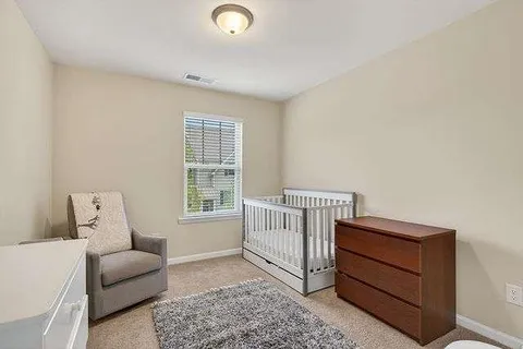 a bedroom with furniture and a window