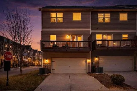 a front view of a residential apartment building with a yard
