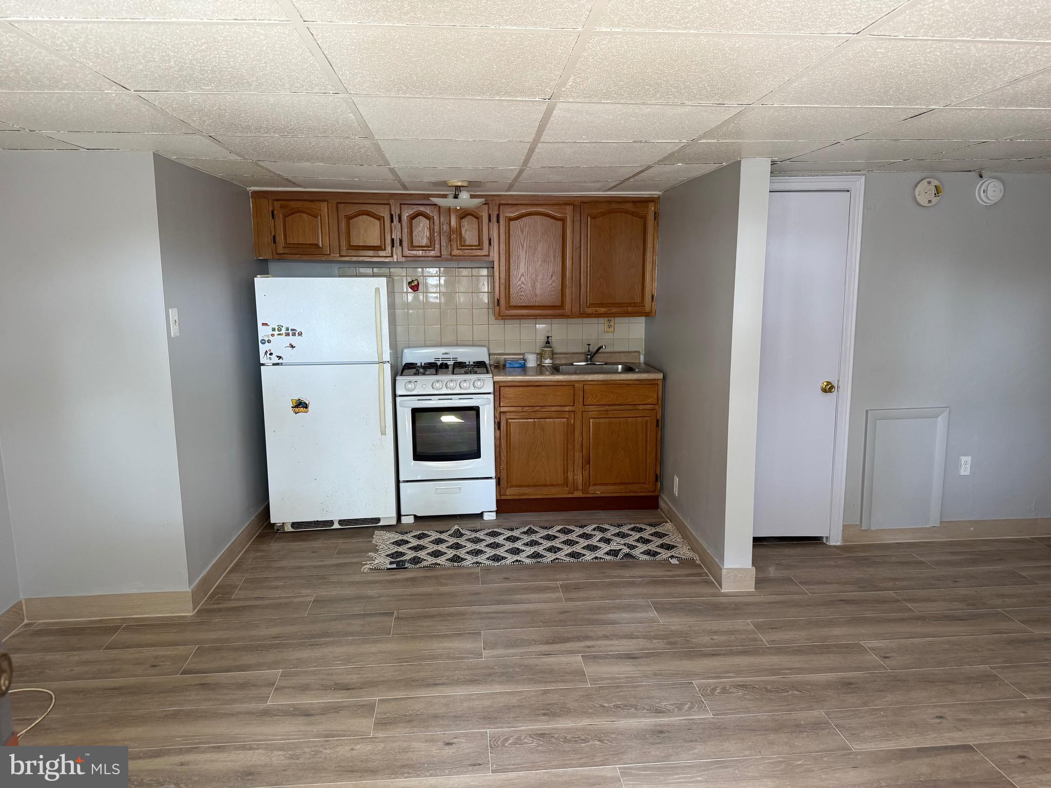 1041 Fanshawe Street Philadelphia, PA 19111 - Photo 4 of 6 a kitchen with stainless steel appliances granite countertop a stove a refrigerator and a microwave