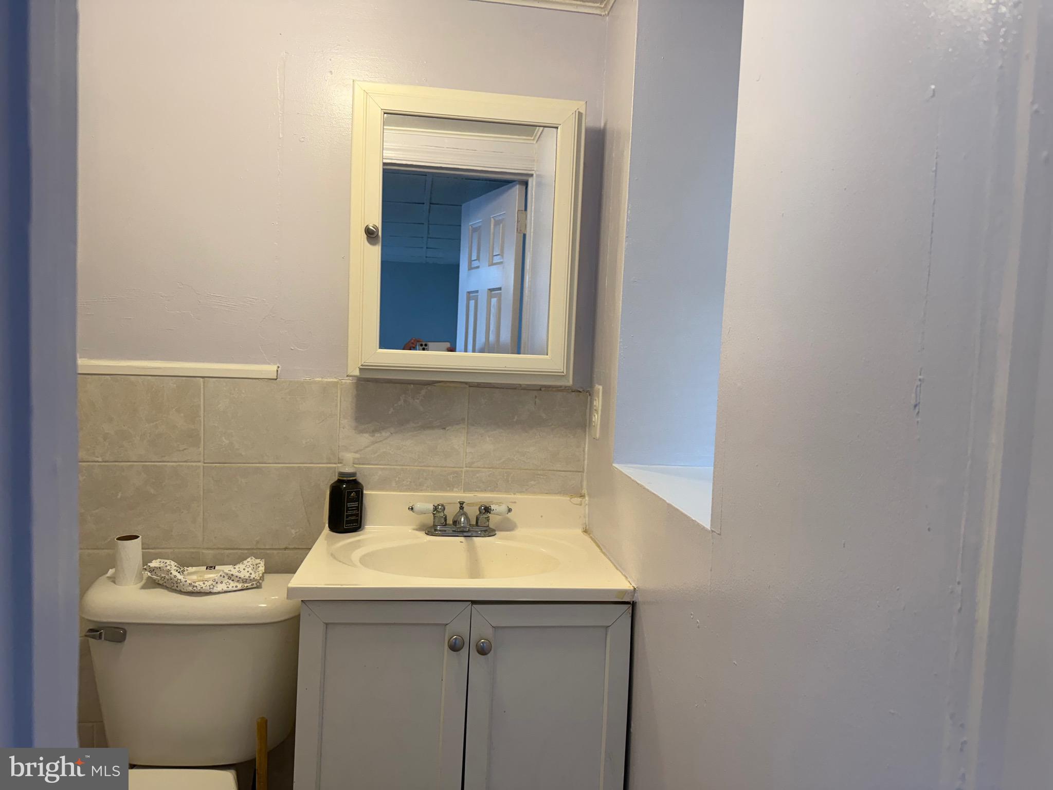 1041 Fanshawe Street Philadelphia, PA 19111 - Photo 5 of 6 a bathroom with a sink and mirror