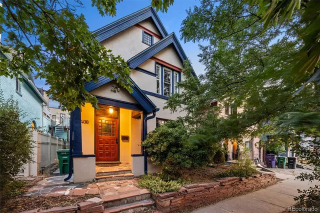 a view of a house with a tree next to a yard
