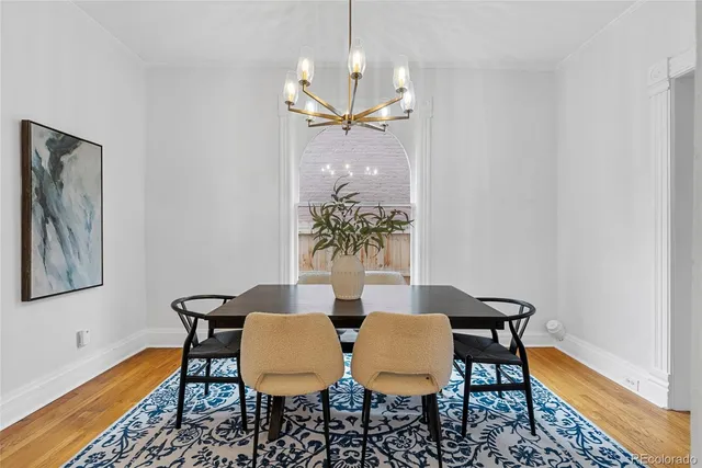 a view of a dining room with furniture and chandelier