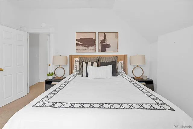 a room with a bed and lamp