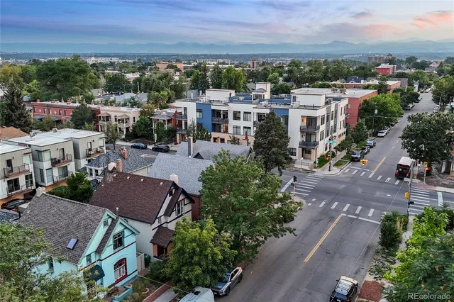 a view of multiple houses with a yard