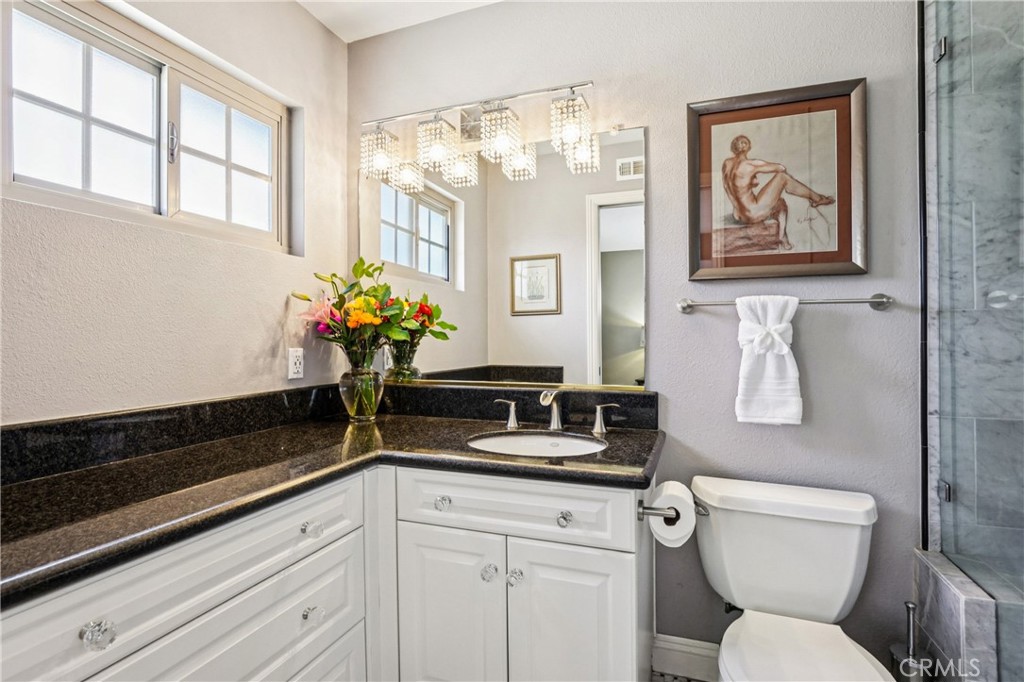 13541 Dean Street Tustin, CA 92780 - Photo 11 of 30 a bathroom with a toilet a sink and a window