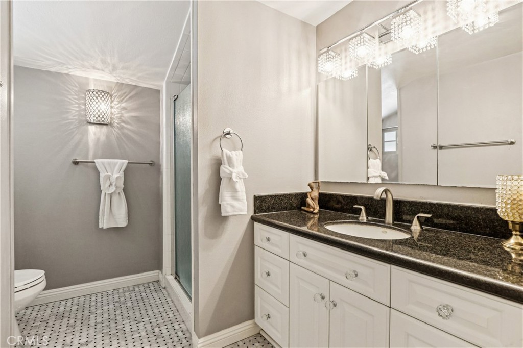 13541 Dean Street Tustin, CA 92780 - Photo 17 of 30 a bathroom with a sink a toilet and shower