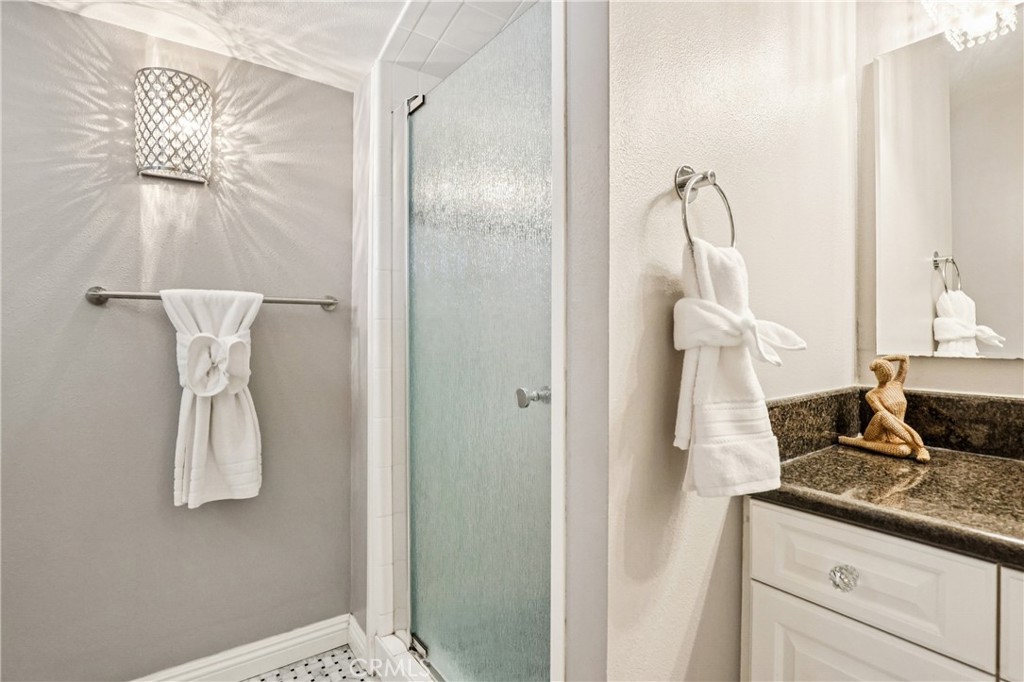 13541 Dean Street Tustin, CA 92780 - Photo 18 of 30 a view of bathroom with a shower and mirror