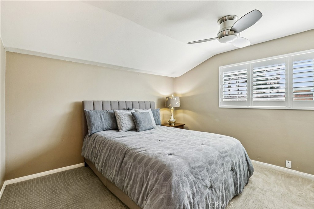 13541 Dean Street Tustin, CA 92780 - Photo 19 of 30 a large bed sitting in a bedroom next to a lamp