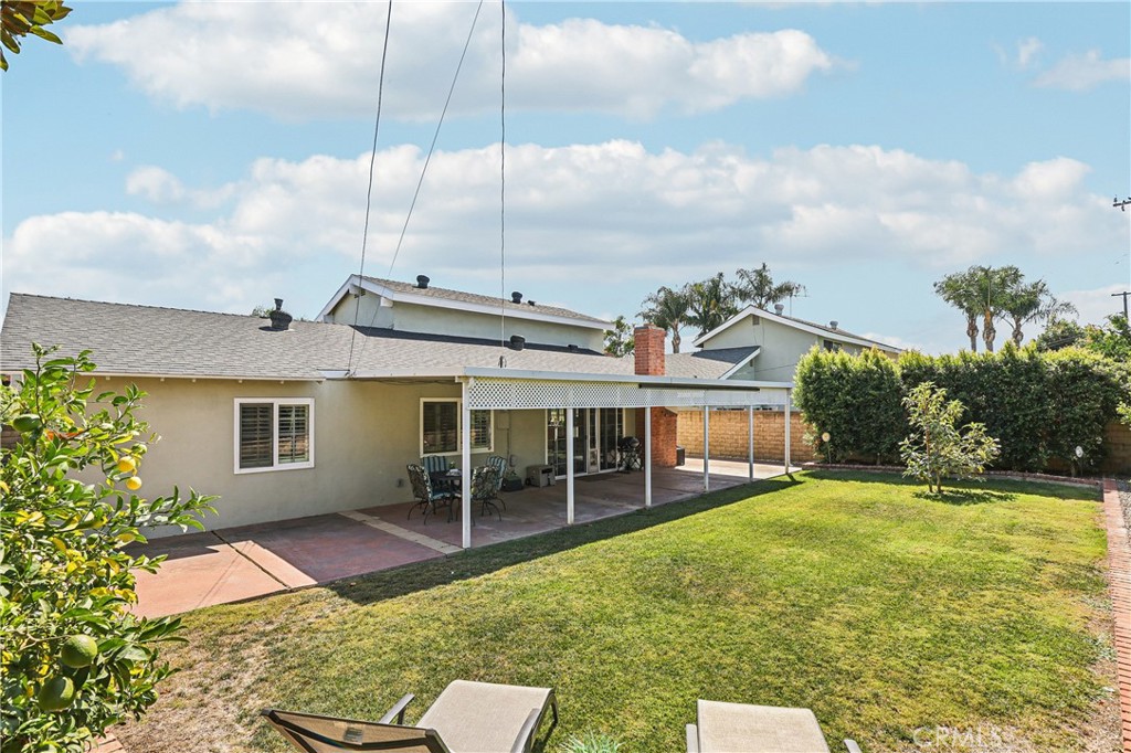 13541 Dean Street Tustin, CA 92780 - Photo 23 of 30 a view of a house with a big yard and potted plants