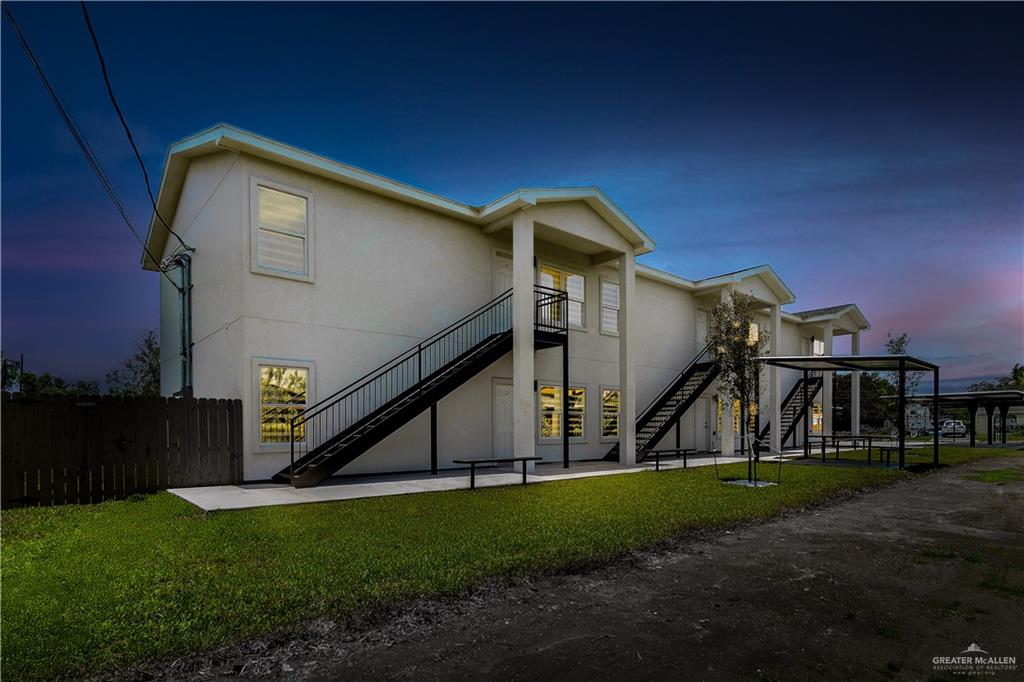 418 North 3rd Street, Unit 2 Donna, TX 78537 - Photo 1 of 1 Rear view of house with stairway, stucco siding, and a patio