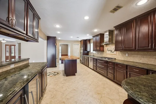 a bathroom with a sink a toilet and a large mirror