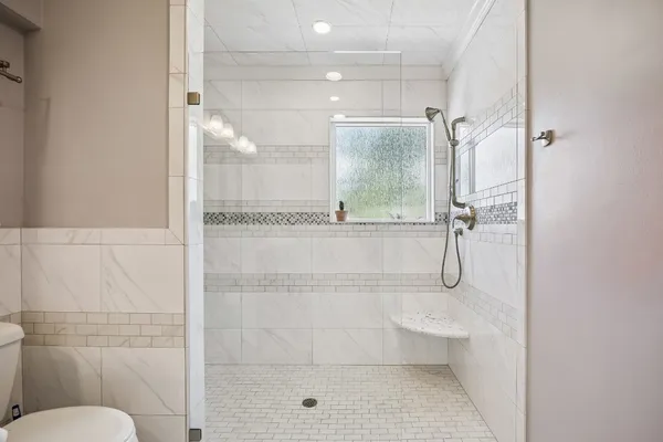a bathroom with a granite countertop sink a toilet and bathtub