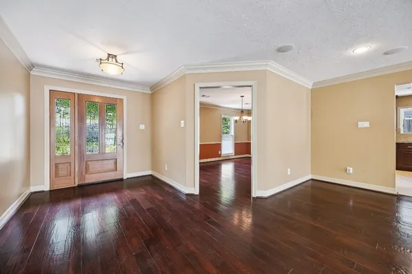 a view of a room with wooden floors