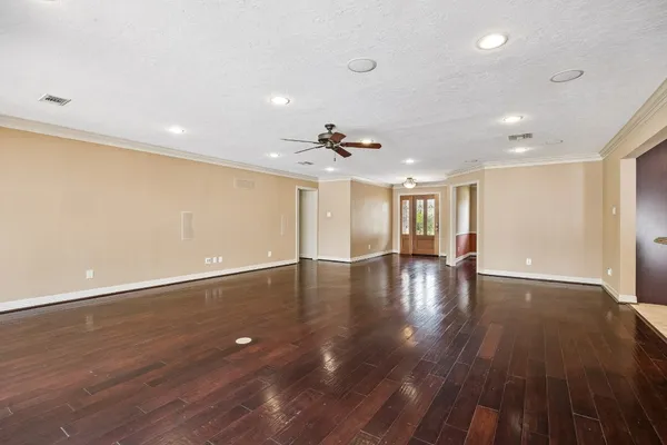 a kitchen with stainless steel appliances granite countertop lots of counter top space and wooden floor