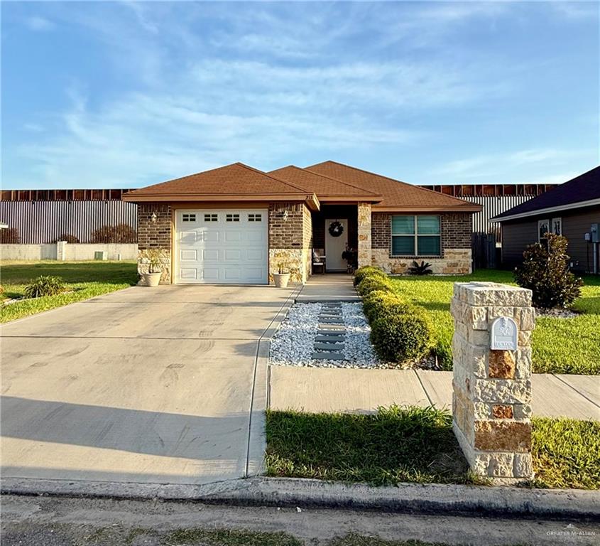 211 Paradise Street Rio Grande City, TX 78582 - Photo 1 of 16 a front view of house with yard and car parked