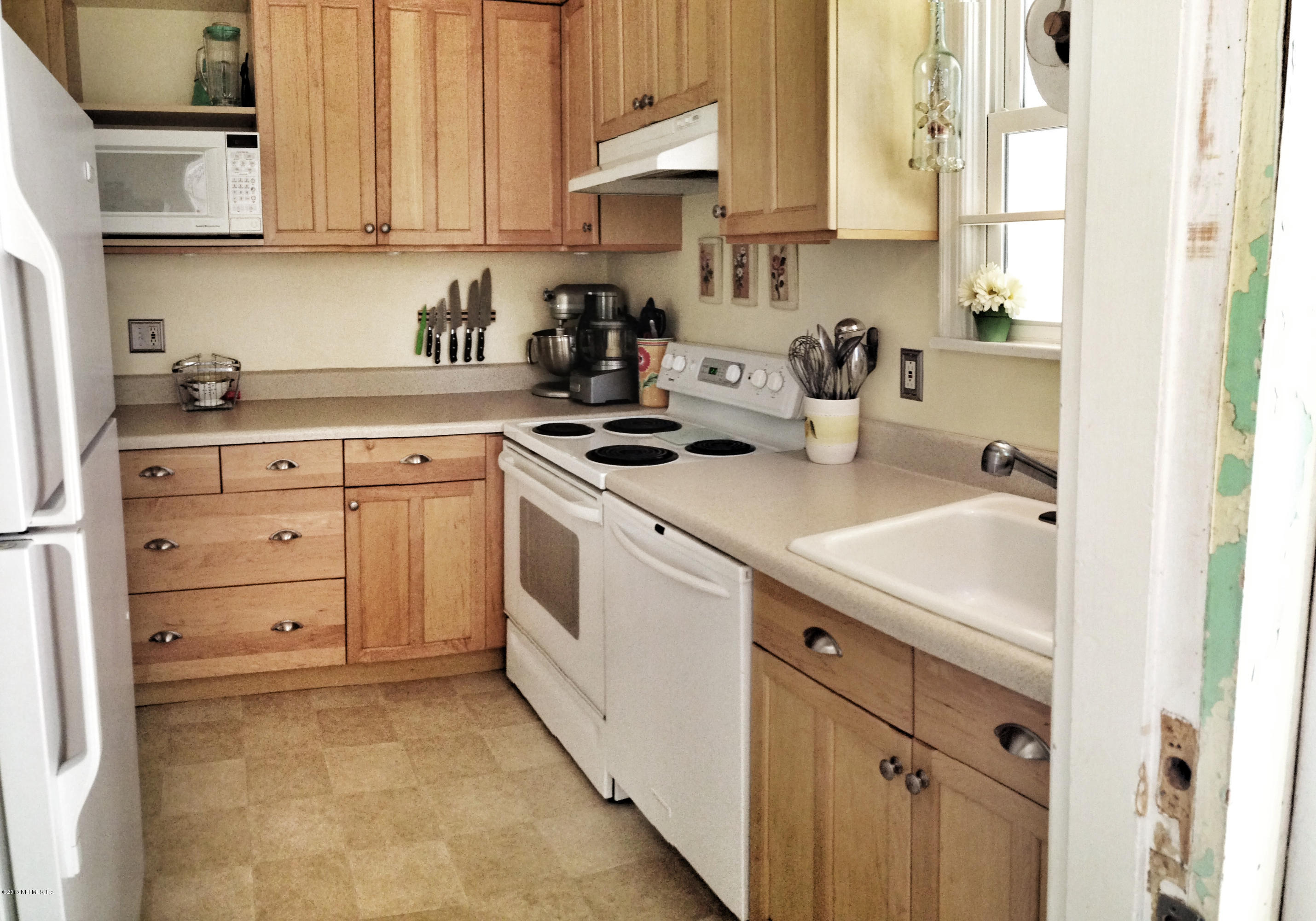 5504 Stetson Road Jacksonville, FL 32207 - Photo 7 of 15 a kitchen with cabinets appliances a sink and a window