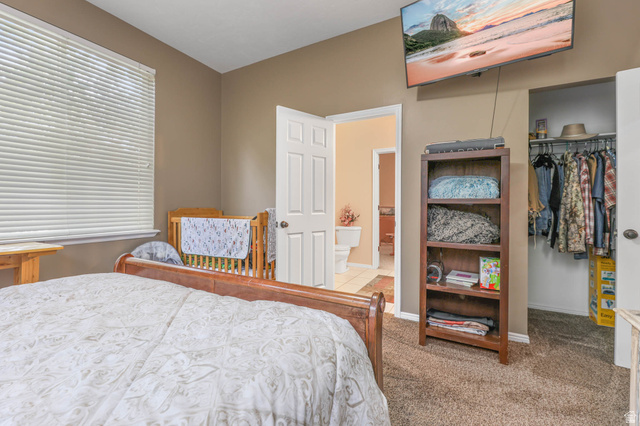 569 Elk Meadow Loop Tooele, UT 84074 - Photo 33 of 56 Carpeted bedroom with baseboards and a spacious closet