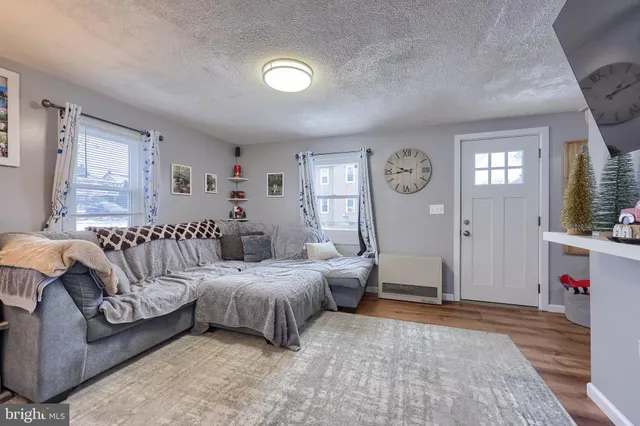 a spacious bedroom with a bed a couch and a window