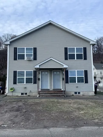 a front view of a house with yard