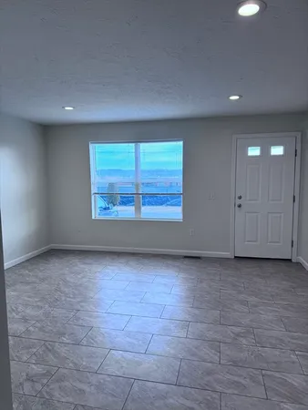 a view of an empty room with a window