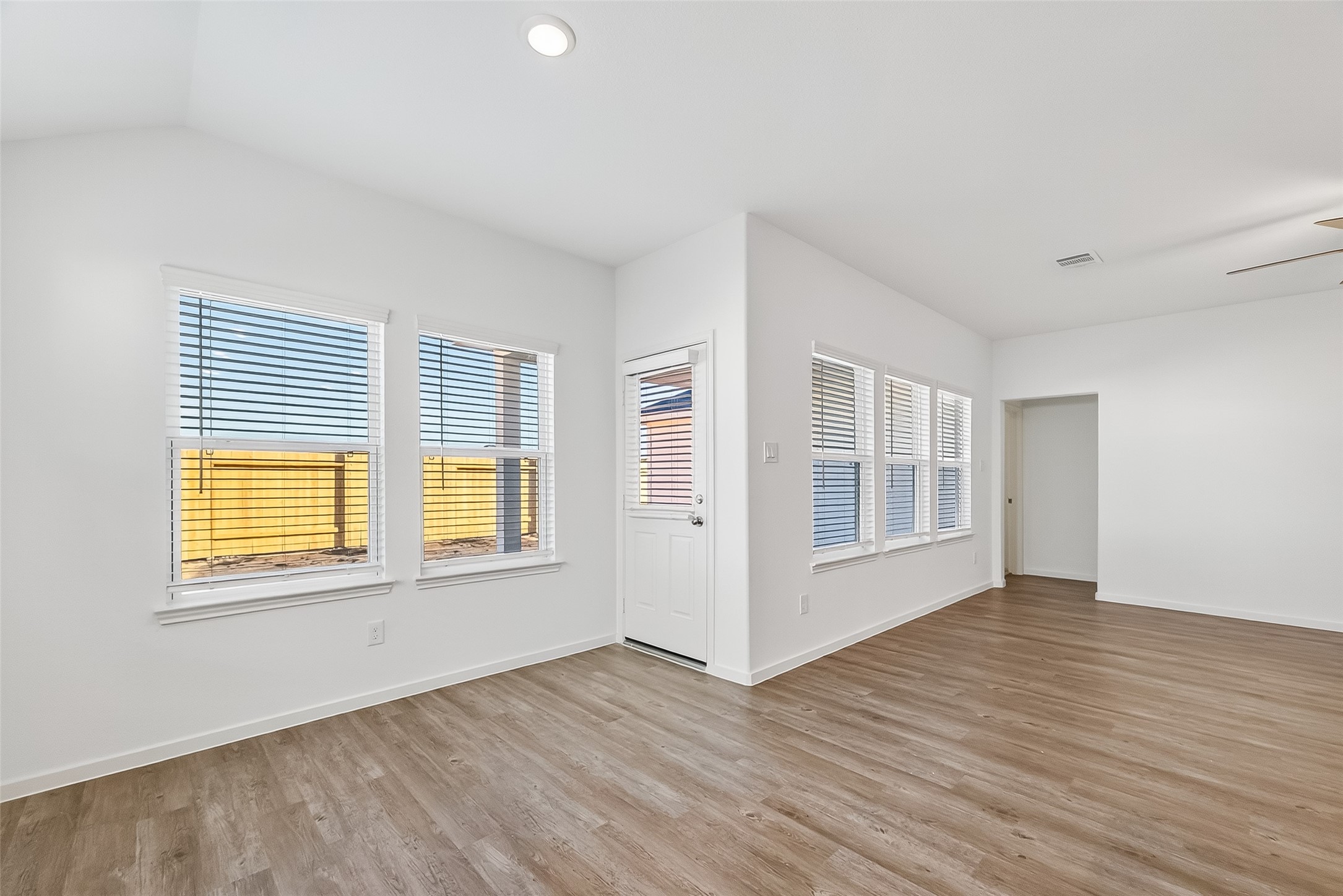 2115 Spring Hollow Drive Baytown, TX 77521 - Photo 12 of 36 a view of an empty room with wooden floor and a window