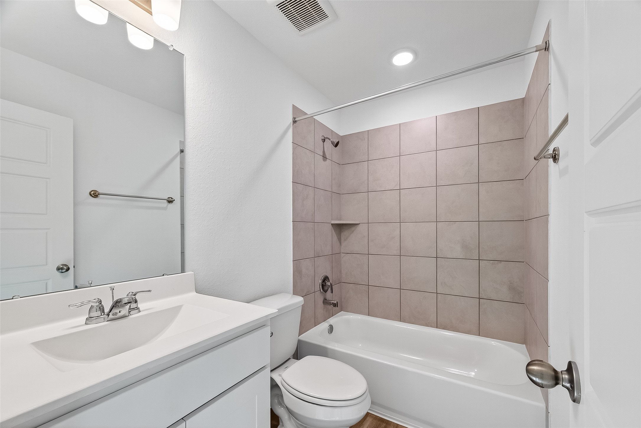 2115 Spring Hollow Drive Baytown, TX 77521 - Photo 22 of 36 a bathroom with a bathtub shower sink vanity mirror and toilet