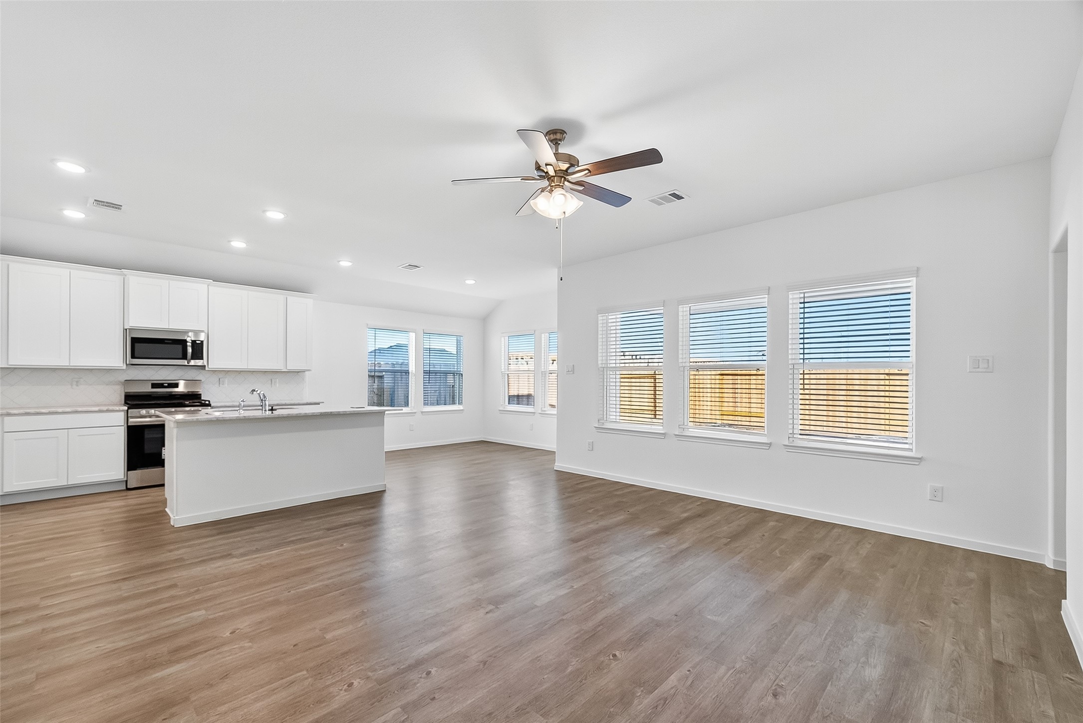 2115 Spring Hollow Drive Baytown, TX 77521 - Photo 5 of 36 a view of an empty room with kitchen and window