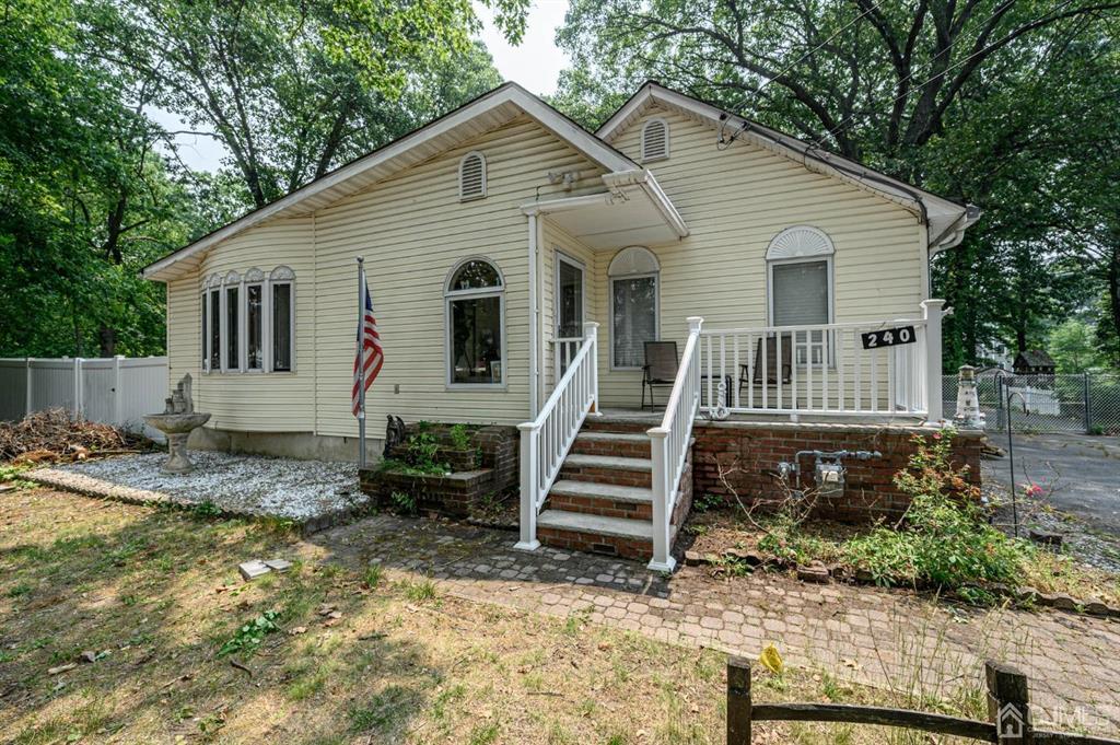 240 Lloyd Road Aberdeen, NJ 07747 - Photo 1 of 29 front view of a house with a yard