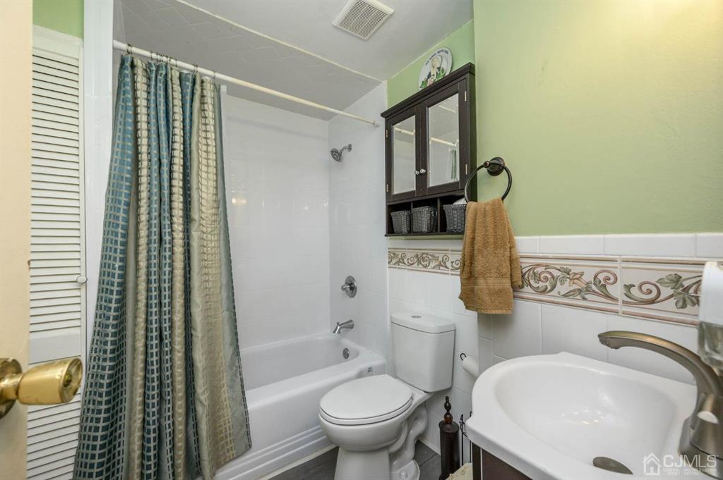 240 Lloyd Road Aberdeen, NJ 07747 - Photo 13 of 29 a bathroom with a sink toilet and shower