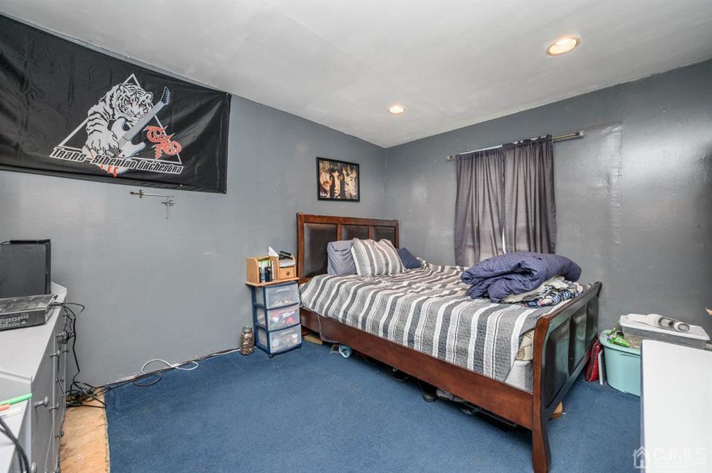240 Lloyd Road Aberdeen, NJ 07747 - Photo 18 of 29 a bedroom with a bed and painting on the wall