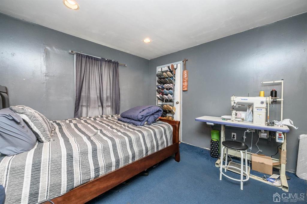 240 Lloyd Road Aberdeen, NJ 07747 - Photo 19 of 29 a bedroom with a bed a desk and chair
