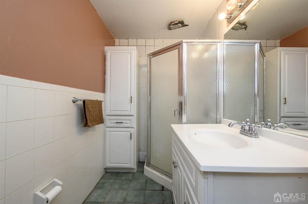 240 Lloyd Road Aberdeen, NJ 07747 - Photo 20 of 29 a bathroom with a sink and mirror