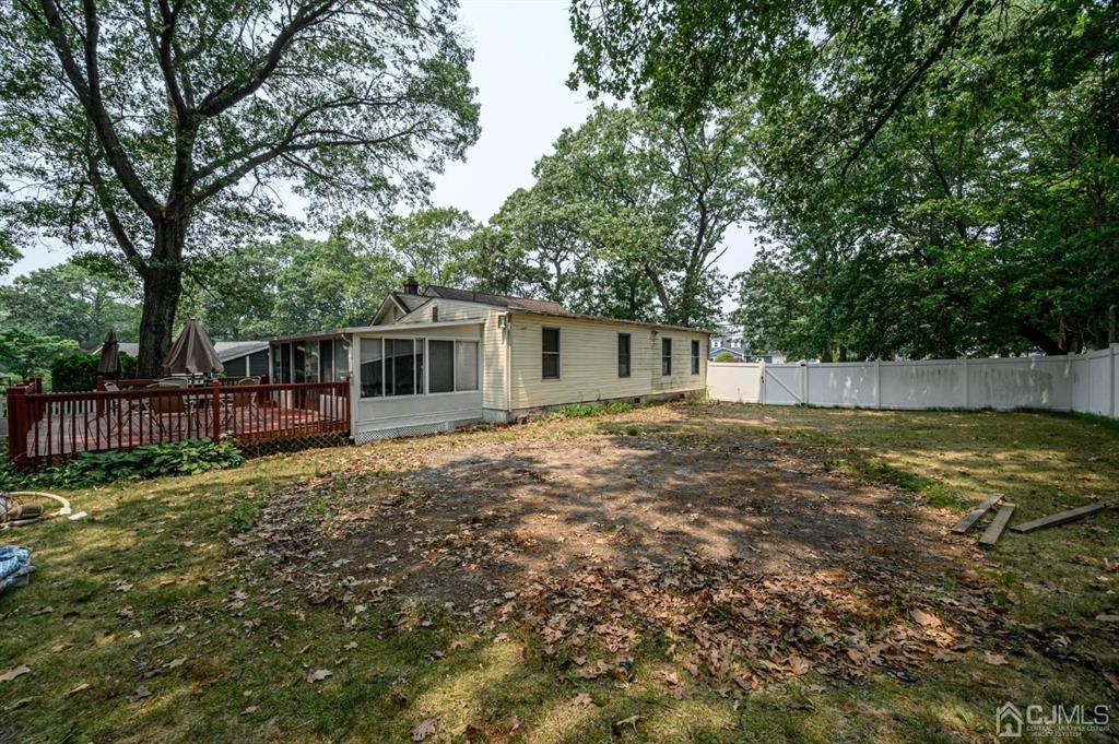 240 Lloyd Road Aberdeen, NJ 07747 - Photo 24 of 29 a backyard of a house with table and chairs