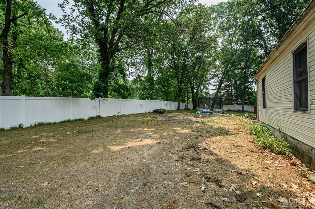 240 Lloyd Road Aberdeen, NJ 07747 - Photo 26 of 29 a view of backyard with tree and wooden fence