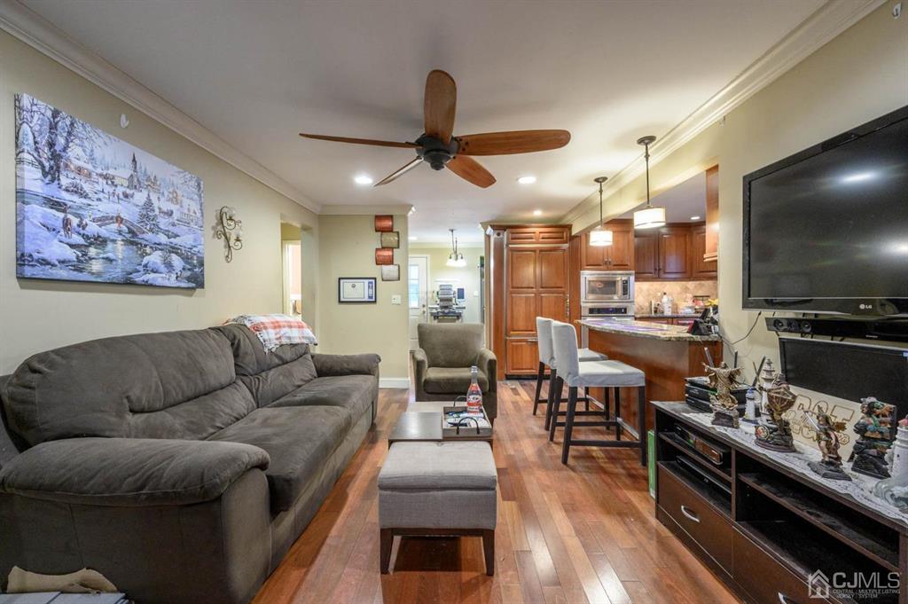 240 Lloyd Road Aberdeen, NJ 07747 - Photo 3 of 29 a living room with furniture and a flat screen tv