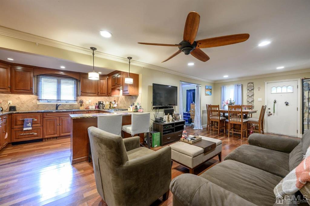 240 Lloyd Road Aberdeen, NJ 07747 - Photo 4 of 29 a living room with furniture kitchen view and a chandelier