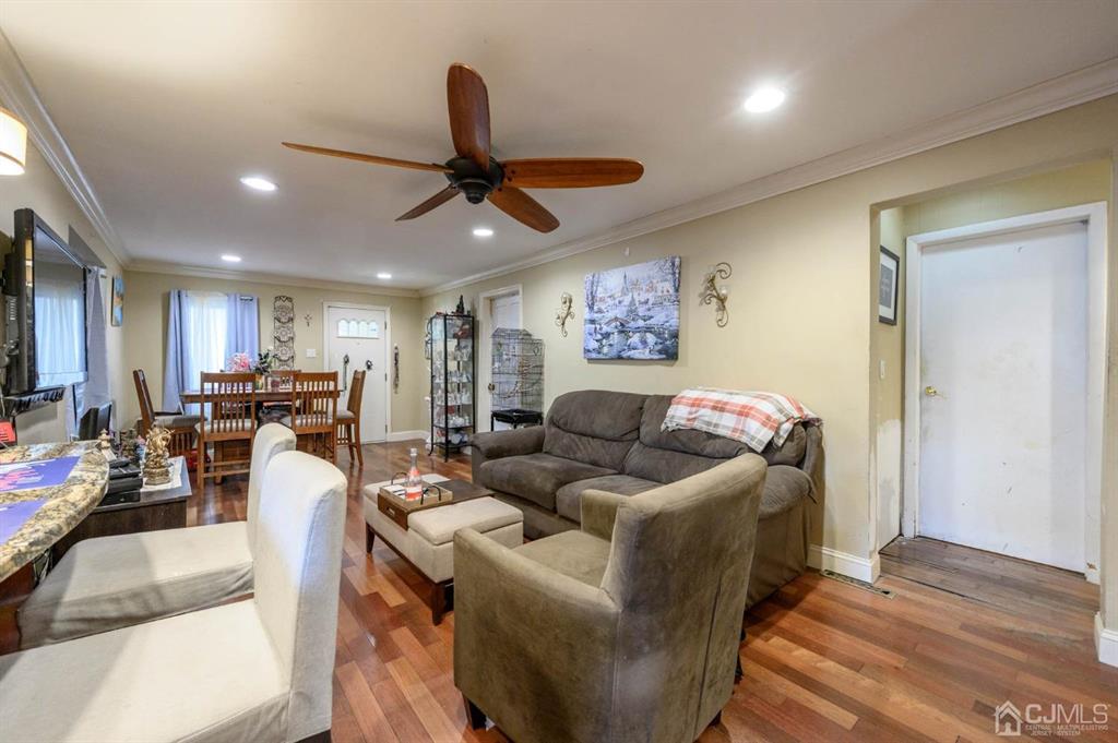 240 Lloyd Road Aberdeen, NJ 07747 - Photo 5 of 29 a living room with furniture and a wooden floor