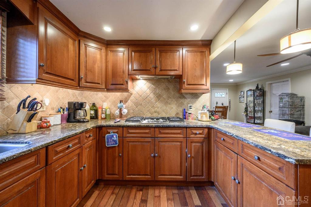 240 Lloyd Road Aberdeen, NJ 07747 - Photo 8 of 29 a kitchen with stainless steel appliances granite countertop wooden cabinets a sink and dishwasher