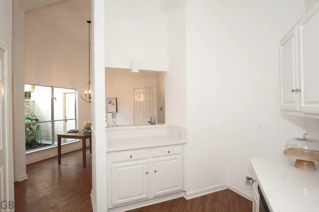 a bathroom with a sink a toilet and a window