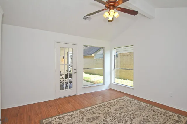 wooden floor in an empty room with a window