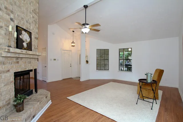 a living room with furniture and a fireplace