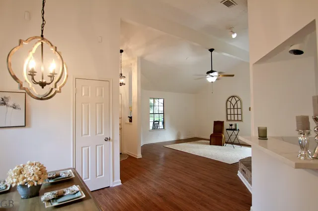 a bedroom with bed and a chandelier