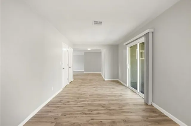 a view of an empty room and wooden floor