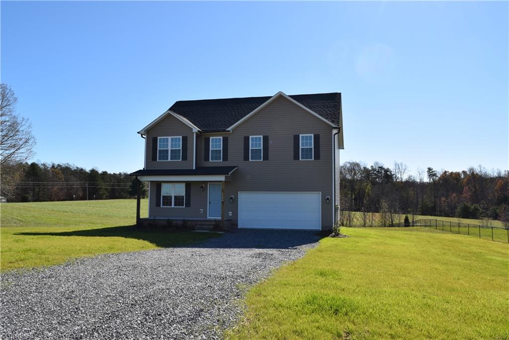 150 Tilly Road Madison, NC 27025 - Photo 32 of 38 Another front view with gravel driveway and 2 car garage