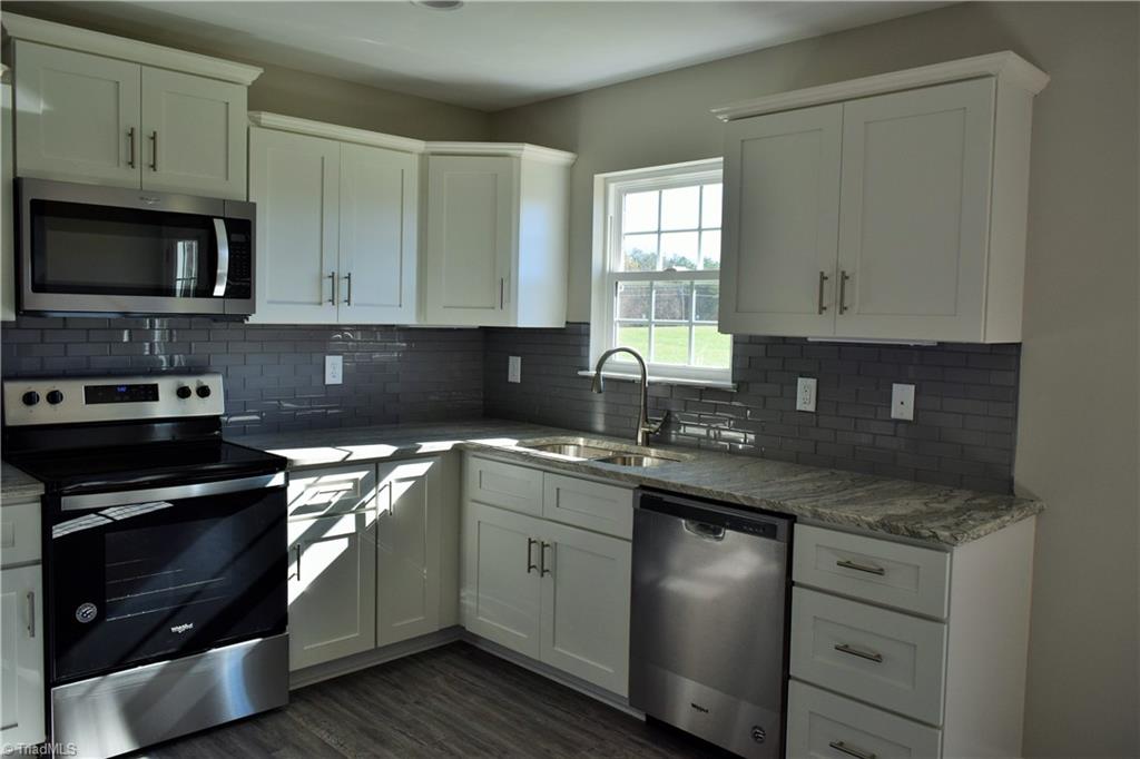 150 Tilly Road Madison, NC 27025 - Photo 8 of 38 Granite counter tops and stainless steel appliances
