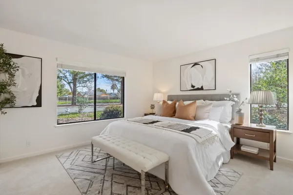 a bedroom with a bed and a painting on the wall