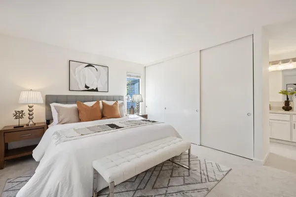 a bathroom with a sink vanity granite and shower