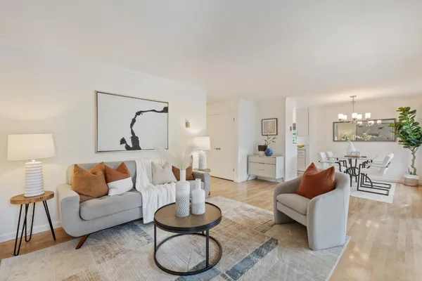 a living room with furniture and a wooden floor
